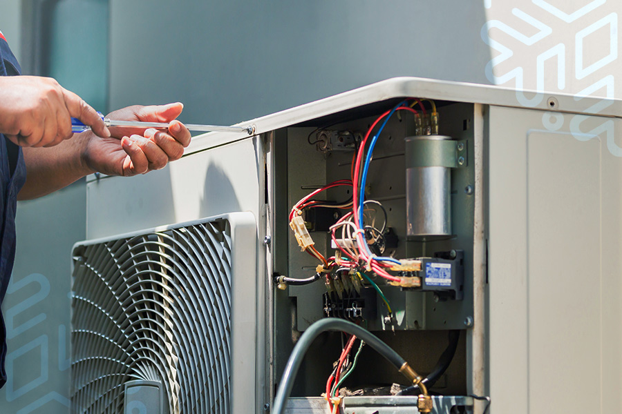 technician repairing air conditioner