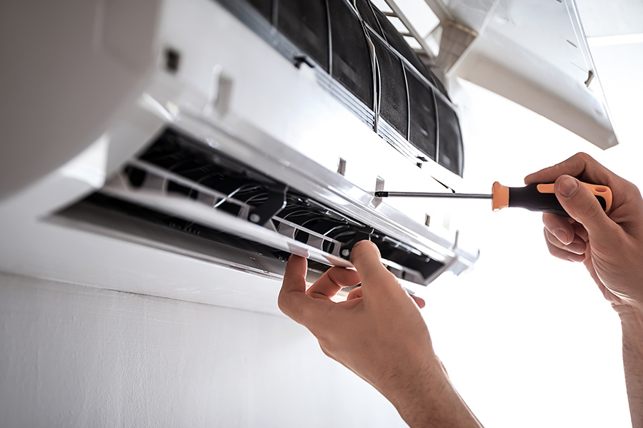 hvac technician installing new ac at property interiors close up pasadena tx