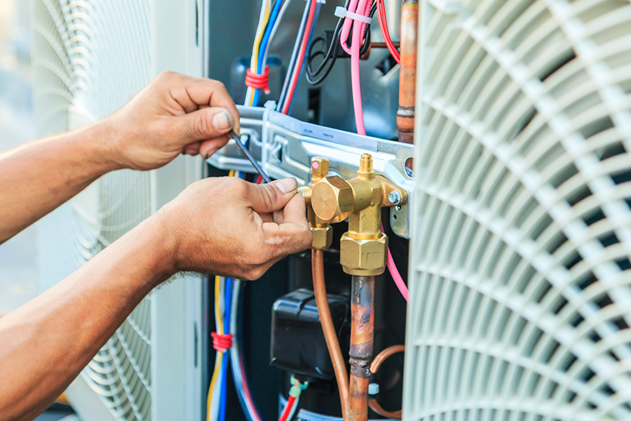 technician hands close up repairing hvac commercial unit jacinto city tx