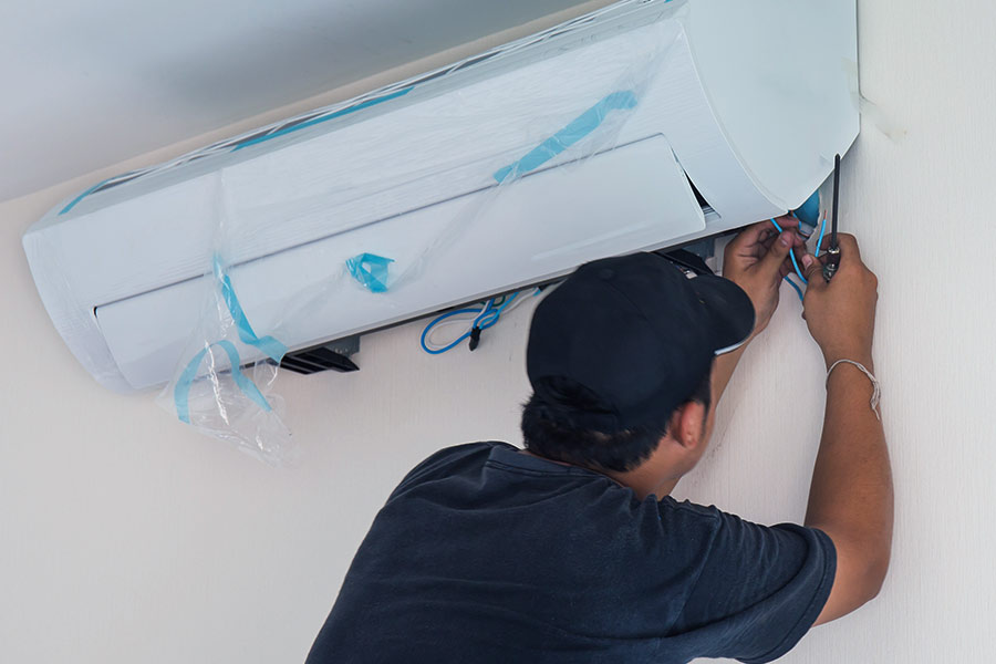 hvac technician installing a new air conditioner as part of air conditioner replacement pasadena tx