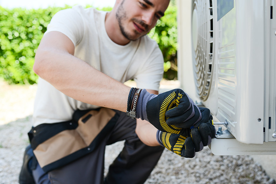 technician close up installing new air conditioner unit at property exteriors highlands tx